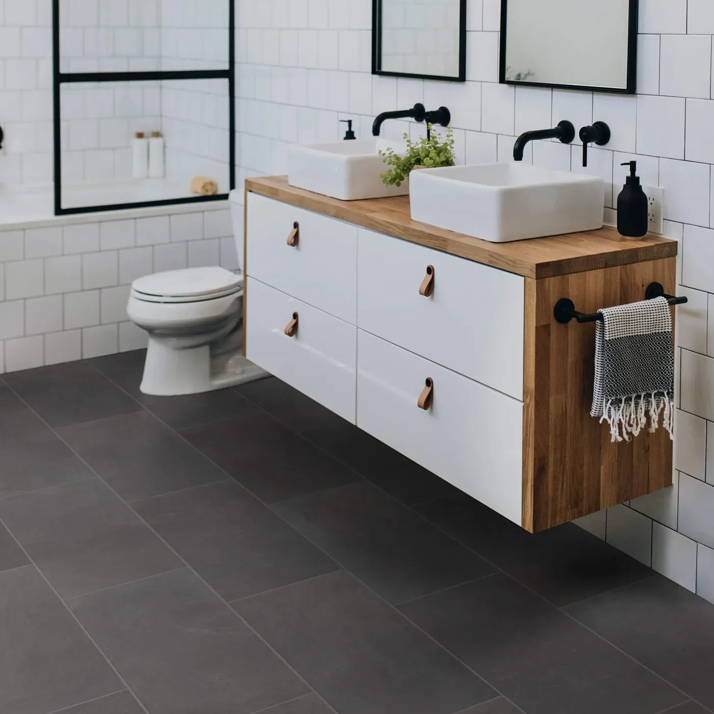 Callisto-12x24-430TS-Ember-00900-RM-V Shaw Floors Ember dark gray rectangular tile in a modern bathroom | Bram Flooring